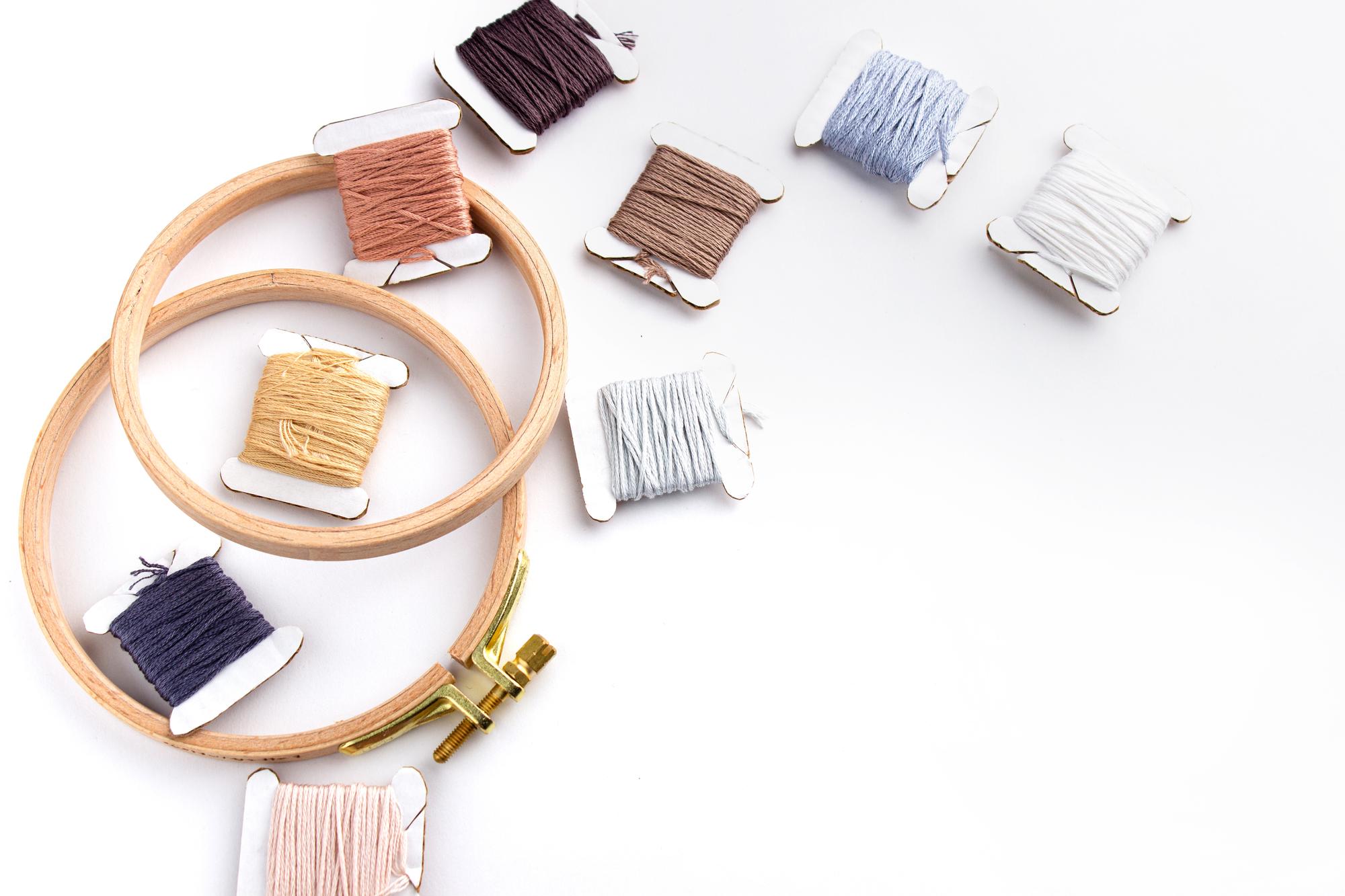 atelier table with spools of thread and samples